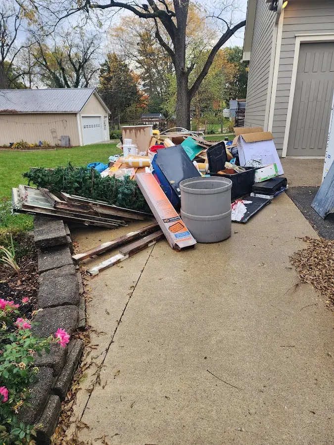 Dumpster being loaded with debris for 12 Yard Dumpster Rental in Hampden